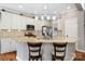 Bright kitchen featuring white cabinetry, granite countertops, stainless steel appliances, and a breakfast bar at 12312 Mcallister Park Dr, Charlotte, NC 28277