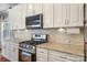 Close-up of the kitchen with stainless steel appliances, granite countertops, and white cabinetry at 12312 Mcallister Park Dr, Charlotte, NC 28277