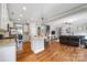 Spacious living room with hardwood floors, fireplace, and open kitchen layout at 12312 Mcallister Park Dr, Charlotte, NC 28277