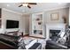 Cozy living room featuring a fireplace, ceiling fan, and stylish decor at 12312 Mcallister Park Dr, Charlotte, NC 28277