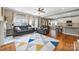 Open-concept living room featuring hardwood floors, a colorful rug, and seamless flow to the kitchen at 12312 Mcallister Park Dr, Charlotte, NC 28277