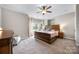 Spacious main bedroom with a bay window, plush carpet, and a ceiling fan at 12312 Mcallister Park Dr, Charlotte, NC 28277