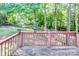 Wooden back deck overlooks lush green scenery at 125 Shenandoah Loop, Troutman, NC 28166