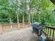 Deck overlooking a wooded backyard and a grill, great for barbecues and outdoor gatherings at 125 Shenandoah Loop, Troutman, NC 28166
