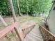 View of the backyard from the deck stairs with privacy fence and house exterior at 125 Shenandoah Loop, Troutman, NC 28166