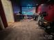 Finished basement features a large screen, exercise equipment and seating area at 125 Shenandoah Loop, Troutman, NC 28166