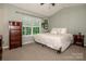 Main bedroom featuring a large window, a dresser, and wood wall trim at 125 Shenandoah Loop, Troutman, NC 28166