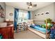 A bedroom with blue walls, a toy organizer, and a window for natural light at 125 Shenandoah Loop, Troutman, NC 28166