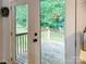 View of backyard deck and surrounding greenery through glass doors at 125 Shenandoah Loop, Troutman, NC 28166