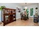 Bright dining area featuring light wood floors, a wooden table set, and access to the back deck at 125 Shenandoah Loop, Troutman, NC 28166