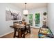 Bright dining area featuring light wood floors, a wooden table set, and access to the back deck at 125 Shenandoah Loop, Troutman, NC 28166
