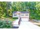 Charming two-story home with a well-manicured lawn, attached garage, and inviting front entrance surrounded by mature trees at 125 Shenandoah Loop, Troutman, NC 28166