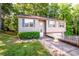 Charming home featuring a well-manicured lawn and an attached garage at 125 Shenandoah Loop, Troutman, NC 28166