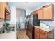 Well-lit kitchen with stainless steel refrigerator, wood cabinets, and bright lighting at 125 Shenandoah Loop, Troutman, NC 28166