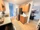 Bright kitchen with stainless steel fridge, open to the dining area with wood floors at 125 Shenandoah Loop, Troutman, NC 28166