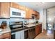 A functional kitchen with wood cabinets and stainless steel appliances for meal preparation and enjoyment at 125 Shenandoah Loop, Troutman, NC 28166