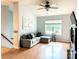 Bright living room featuring wood floors, a vaulted ceiling, and a comfortable sofa at 125 Shenandoah Loop, Troutman, NC 28166