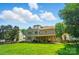 Expansive backyard view showcasing the well-maintained lawn, and the rear exterior of the home at 129 N Audubon Ave, Mooresville, NC 28117