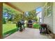 Outdoor cooking area with built-in grill and brick pizza oven overlooking a lush, green yard at 129 N Audubon Ave, Mooresville, NC 28117