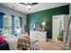 Inviting bedroom with dark green accent wall, and plenty of natural light at 129 N Audubon Ave, Mooresville, NC 28117