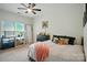 Bright bedroom with a ceiling fan, a large window, and modern décor at 129 N Audubon Ave, Mooresville, NC 28117