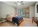 Cozy bedroom featuring neutral walls, carpet, ceiling fan, and a window with wood shutters at 129 N Audubon Ave, Mooresville, NC 28117