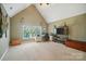Bonus room with vaulted ceiling, a window, carpet, and a TV, offering flexible space at 129 N Audubon Ave, Mooresville, NC 28117