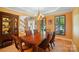 A formal dining room features a wood table with seating, and natural light from window at 129 N Audubon Ave, Mooresville, NC 28117