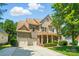 Beautiful two-story home featuring a two-car garage, charming front porch, and meticulously landscaped yard at 129 N Audubon Ave, Mooresville, NC 28117