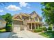 Beautiful two-story home featuring a two-car garage, charming front porch, and meticulously landscaped yard at 129 N Audubon Ave, Mooresville, NC 28117