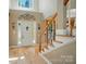 Welcoming foyer with gleaming hardwood floors, staircase, and decorative details around the front door at 129 N Audubon Ave, Mooresville, NC 28117