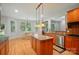 Bright kitchen with a center island, pendant lighting, and adjacent dining area, perfect for entertaining at 129 N Audubon Ave, Mooresville, NC 28117