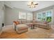 Comfortable living room with hardwood floors, neutral tones, and a large sectional sofa for relaxing at 129 N Audubon Ave, Mooresville, NC 28117