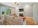 Spacious living room featuring a fireplace, large windows, and comfortable seating arrangement at 129 N Audubon Ave, Mooresville, NC 28117