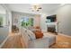 Spacious living room featuring a fireplace, large windows, and comfortable seating arrangement at 129 N Audubon Ave, Mooresville, NC 28117