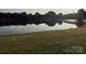 Scenic pond view reflecting trees and sky for a peaceful and tranquil community at 129 N Audubon Ave, Mooresville, NC 28117
