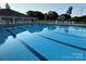 A community pool with lane markers, lounge chairs, umbrellas, and a clubhouse for summer enjoyment at 129 N Audubon Ave, Mooresville, NC 28117