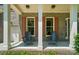 Inviting front porch with brick accents, sturdy columns, and comfortable seating for relaxing outdoors at 129 N Audubon Ave, Mooresville, NC 28117