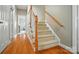 Elegant staircase with carpeted steps and wooden handrails, leading upstairs at 129 N Audubon Ave, Mooresville, NC 28117
