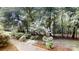 Landscaped backyard with a brick pathway winding through lush greenery and mature trees at 139 Cricket Creek Dr, Cherryville, NC 28021