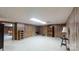 Large basement with wood paneled walls, light carpet and recessed lighting with an armoire and side tables at 139 Cricket Creek Dr, Cherryville, NC 28021