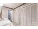 Bathroom with double sinks, multiple closets, and floral wallpaper, ensuring style and storage at 139 Cricket Creek Dr, Cherryville, NC 28021