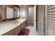 Bathroom with a vanity, a sink, and floral wallpaper next to a doorway at 139 Cricket Creek Dr, Cherryville, NC 28021
