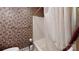 Cozy bathroom featuring a floral patterned wall, a toilet, and a shower with a white curtain at 139 Cricket Creek Dr, Cherryville, NC 28021