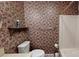 Bathroom featuring floral wallpaper, toilet, shelf and a shower-tub combination at 139 Cricket Creek Dr, Cherryville, NC 28021