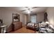 Charming bedroom featuring patterned wallpaper, a wooden dresser, and a large window at 139 Cricket Creek Dr, Cherryville, NC 28021