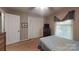 Cozy bedroom with striped wallpaper, closet, and dark wood dresser at 139 Cricket Creek Dr, Cherryville, NC 28021