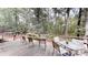 Wooden deck with outdoor seating overlooking lush backyard landscaping and mature trees at 139 Cricket Creek Dr, Cherryville, NC 28021