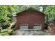 Two car detached brick garage with two overhead doors and mature landscaping at 139 Cricket Creek Dr, Cherryville, NC 28021