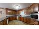 Traditional kitchen with wooden cabinetry, tile floor, and modern appliances at 139 Cricket Creek Dr, Cherryville, NC 28021